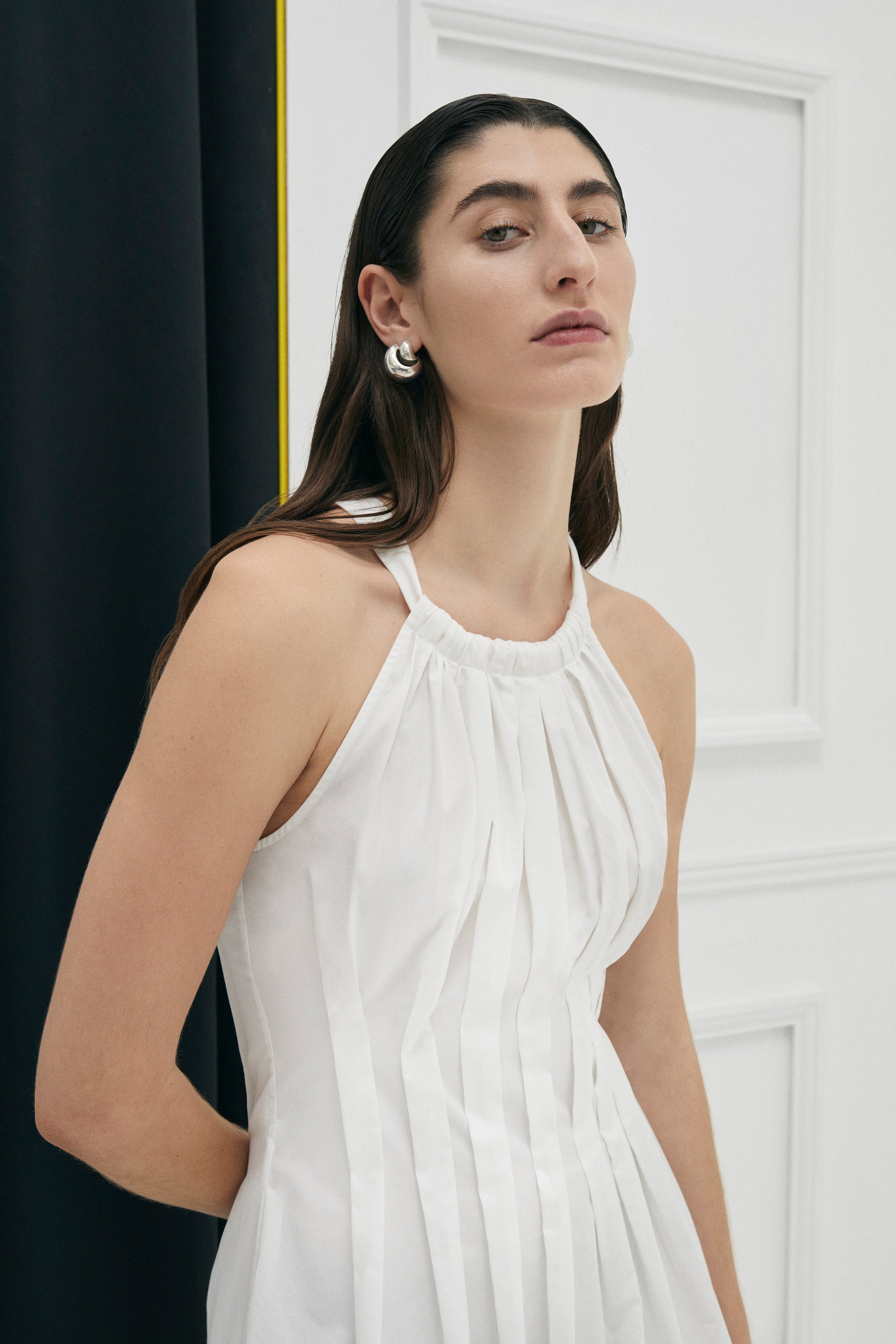 Lucania halter maxi dress in 100% Cotton from Australian designer PALMA MARTÎN.  Uniquely tapered at the waist with shaped box pleats giving the dress a flattering silhouette.