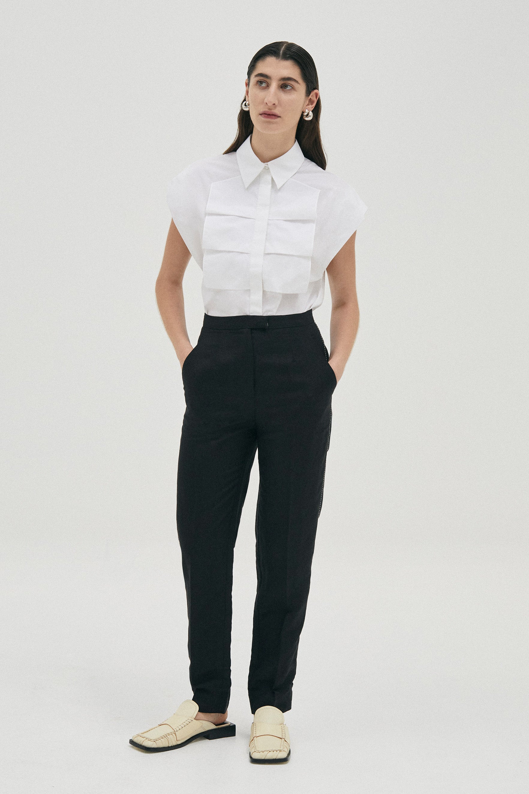 Luxe sleeveless shirt blouse in Cotton from Australian designer PALMA MARTÎN.  Featuring a confident silhouette with wide shoulders, and front ruffle detail. 