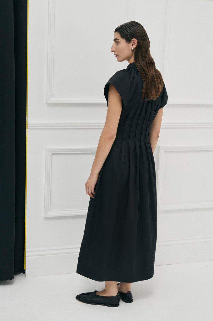 Unchartered shirt dress in Black Cotton by Australian Designer PALMA MARTÎN.  This long black dress style is uniquely tapered at the waist with pleats giving a flattering silhouette. 